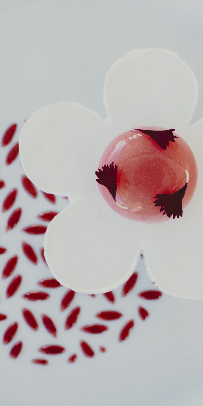 Dessert gourmet con glassa rosa e decorazioni floreali del ristorante Salegrosso
